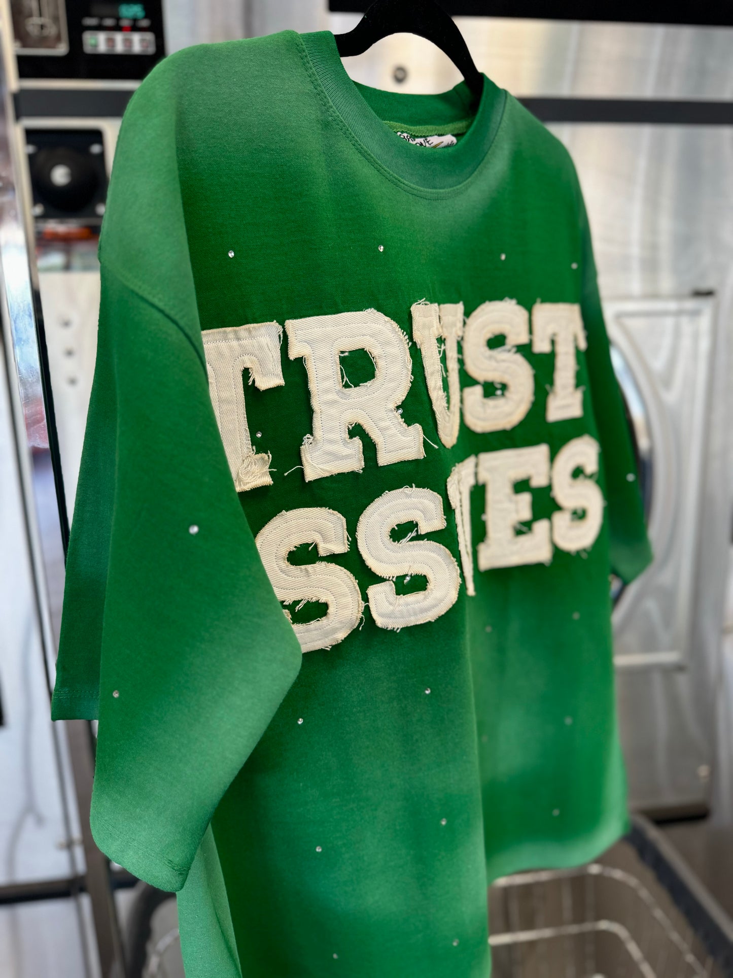 FABRICATED LOVE GREEN & WHITE
“TRUST ISSUES” DROP SHOULD RHINESTONE TEE.