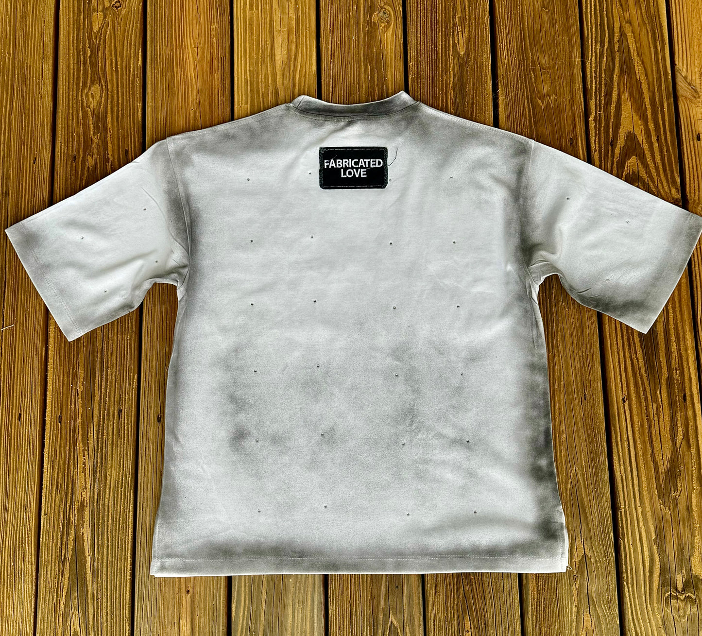 FABRICATED LOVE WHITE & BLACK “TRUST ISSUES” DROP SHOULD RHINESTONE TEE.