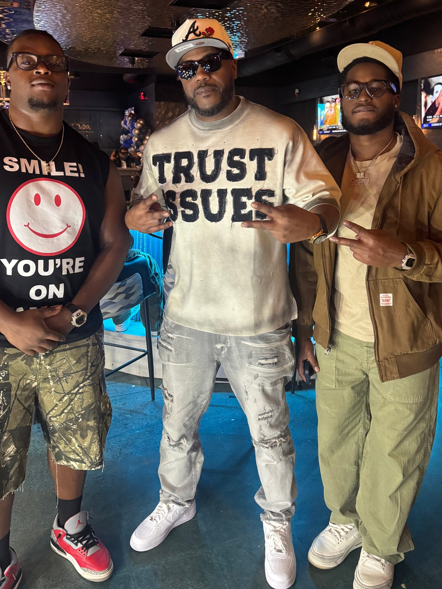 FABRICATED LOVE CREAM & BLACK “TRUST ISSUES” DROP SHOULD RHINESTONE TEE.