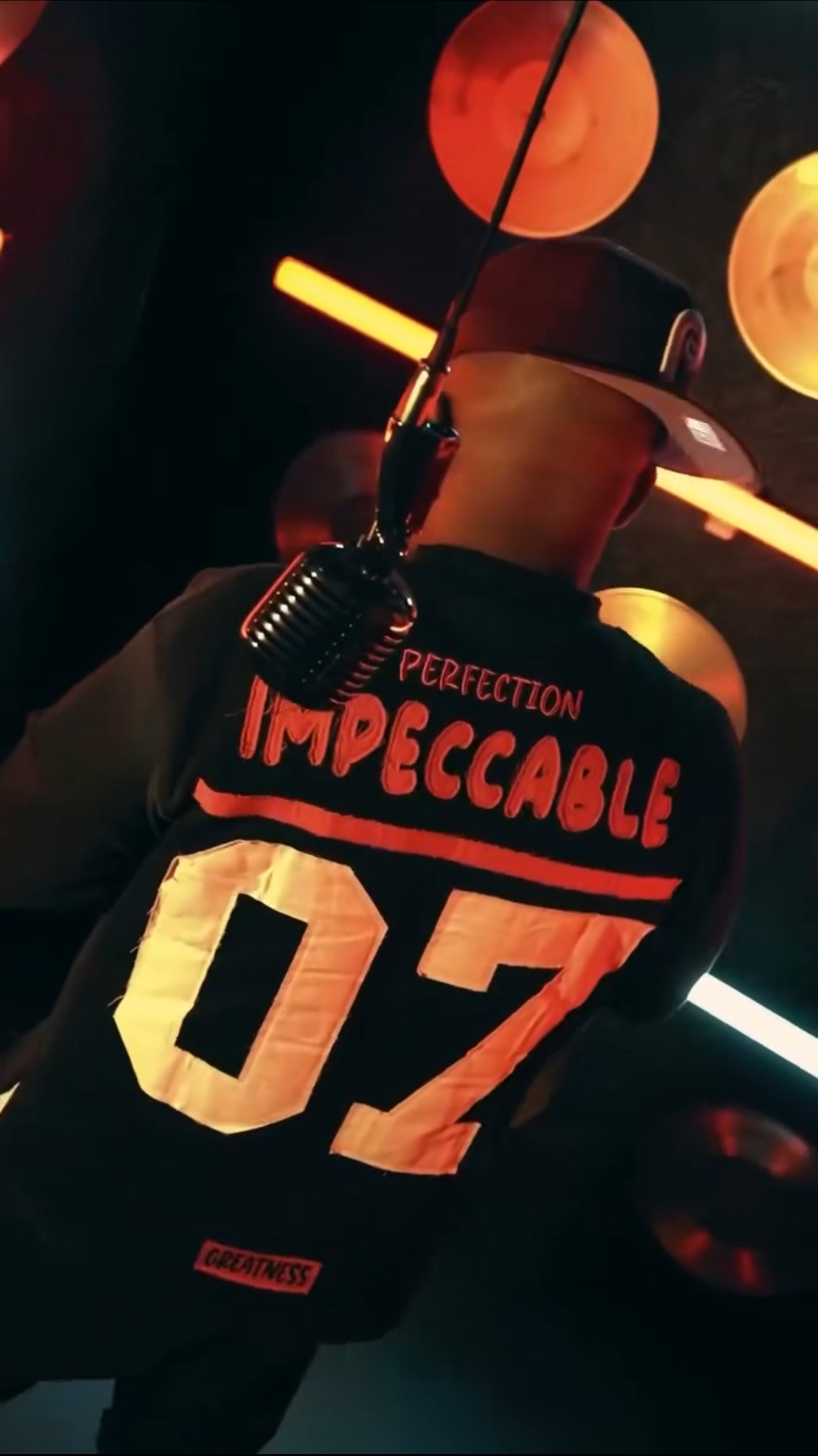 THE G.O.A.T BLACK/FUCHSIA “IMPECCABLE” EMBROIDERY PATCH DROP SHOULDER T-SHIRT